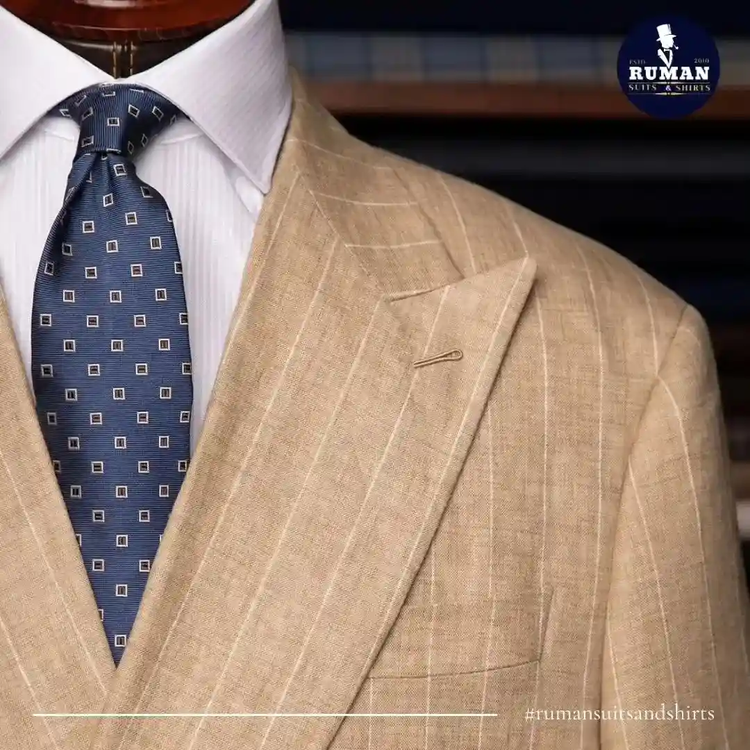 Beige pinstripe tailored suit jacket – bespoke tailoring worth it.