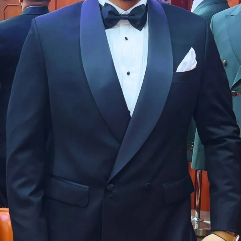 Elegant gentleman wearing a classic tuxedo by Ruman Suits & Shirts, showcasing how to wear a tuxedo with confidence and timeless style.