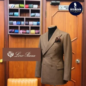 A tailored brown Loro Piana double-breasted suit displayed at Ruman Suits & Shirts Dubai, symbolizing elegance and precision — why fit matters more than fashion in men.