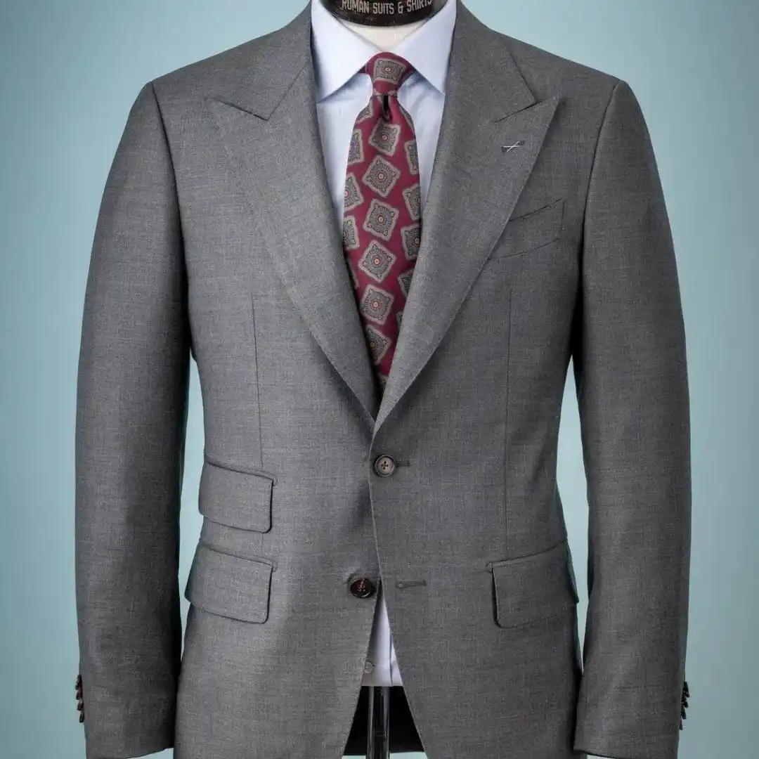 A tailor adjusting a suit jacket, showing the importance of avoiding every suit tailoring mistake to avoid in Dubai for a perfect custom fit.