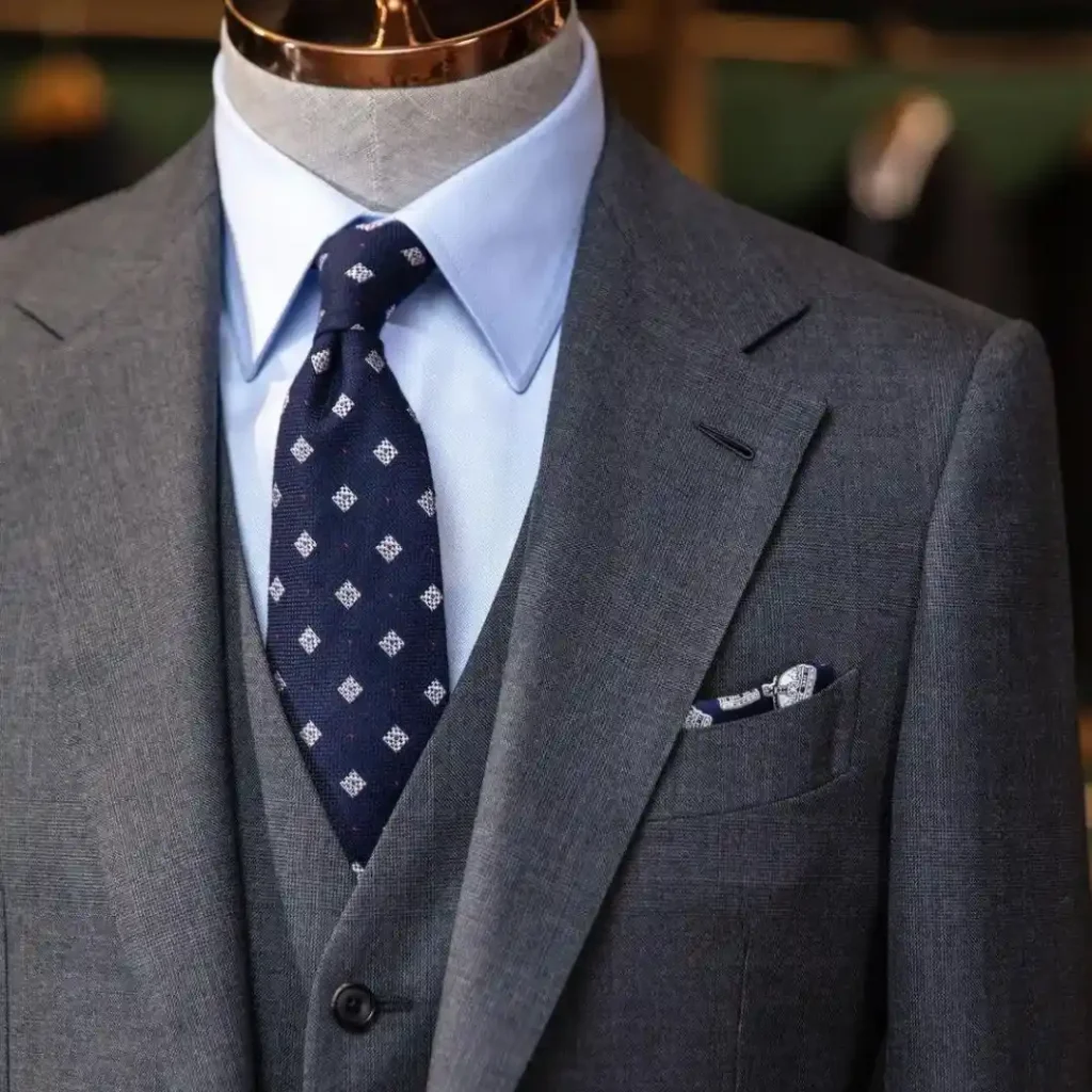 A tailor taking precise measurements of a client’s suit, illustrating key signs of the right tailor through craftsmanship and attention to detail.