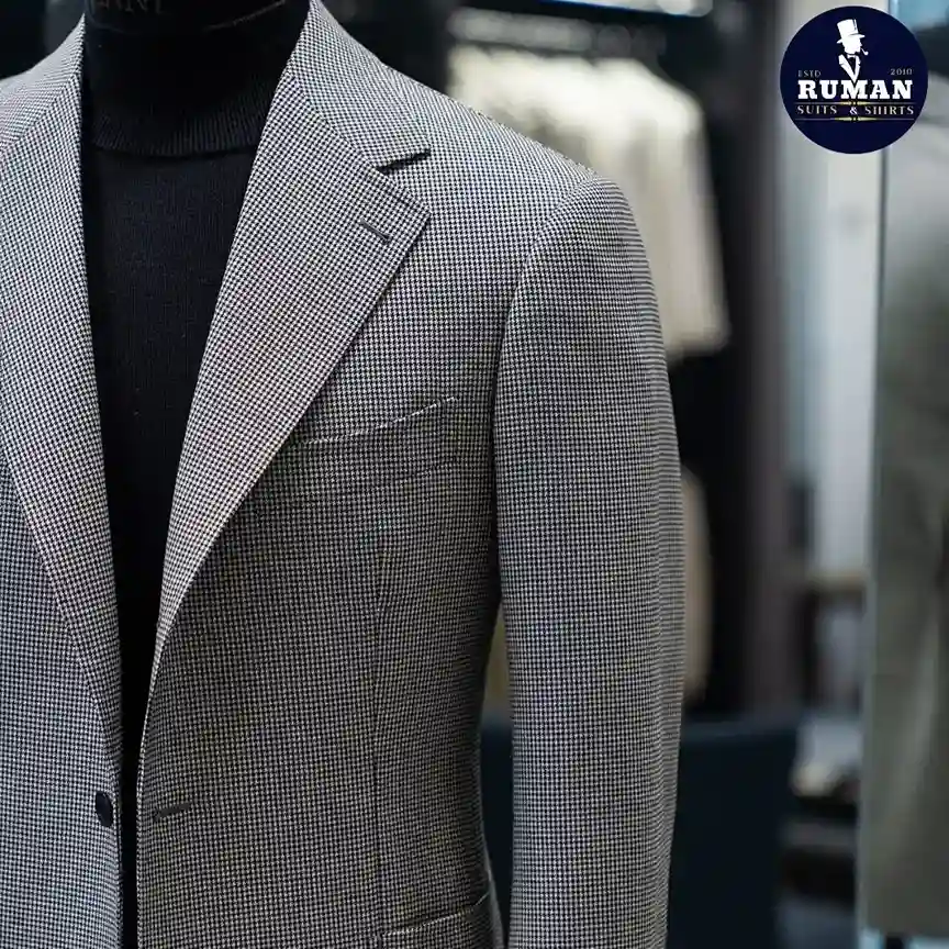 What is a bespoke suit showing detailed craftsmanship, custom measurements, and hand-tailored construction.