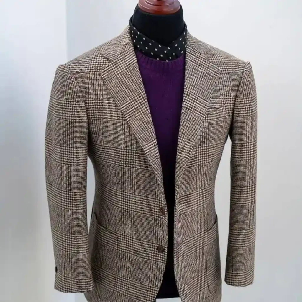 Tailor adjusting a custom jacket illustrating What Makes a Bespoke Suit Better than ready-made suits.