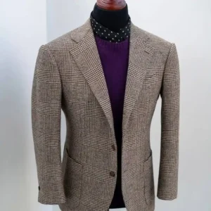 Tailor adjusting a custom jacket illustrating What Makes a Bespoke Suit Better than ready-made suits.