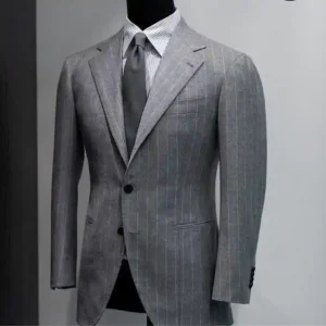 Tailor discussing fabric options and pricing to explain custom suit costs in Dubai during a personalized consultation.
