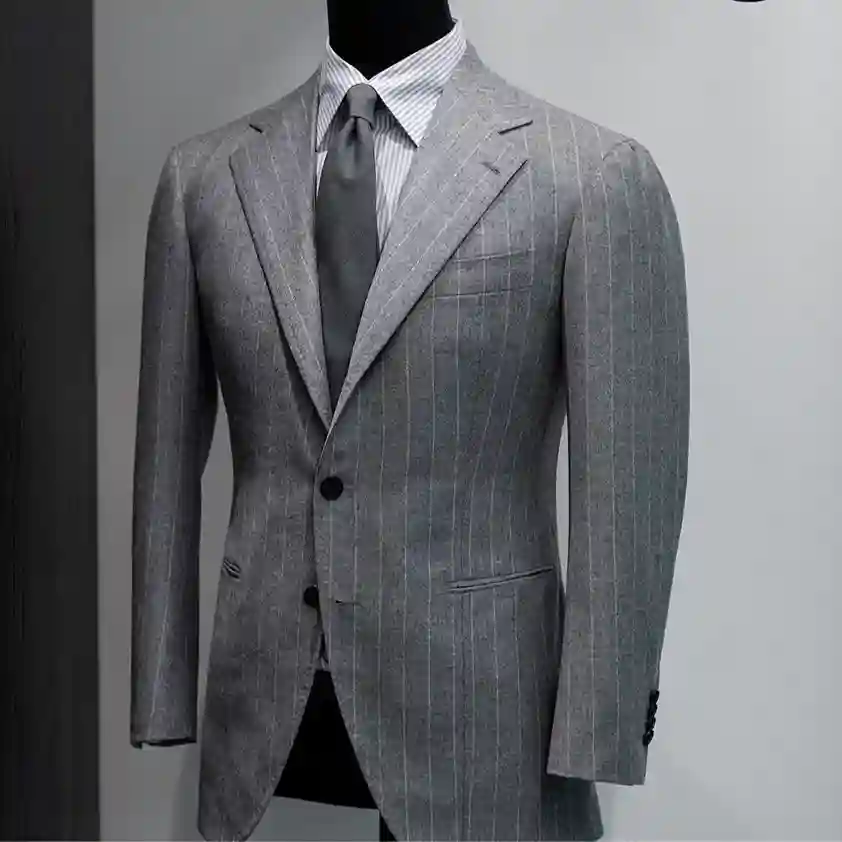 Tailor discussing fabric options and pricing to explain custom suit costs in Dubai during a personalized consultation.