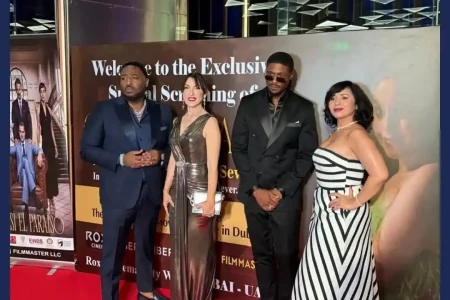 A professional tailor measuring fabric and stitching details, representing the process behind how to dress like a celebrity.