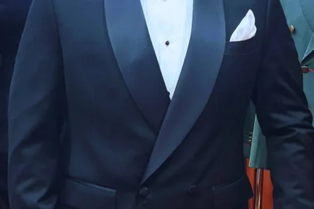 Elegant gentleman wearing a classic tuxedo by Ruman Suits & Shirts, showcasing how to wear a tuxedo with confidence and timeless style.