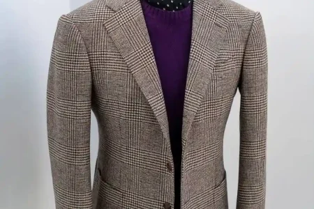 Tailor adjusting a custom jacket illustrating What Makes a Bespoke Suit Better than ready-made suits.